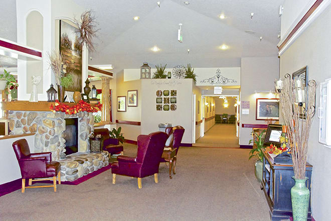 A cozy living room with a fireplace and comfortable seating.