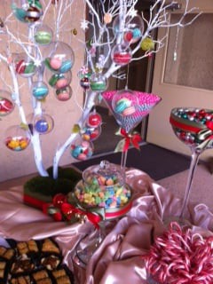 A colorful candy display with decorative elements, including an artificial tree adorned with sweets.