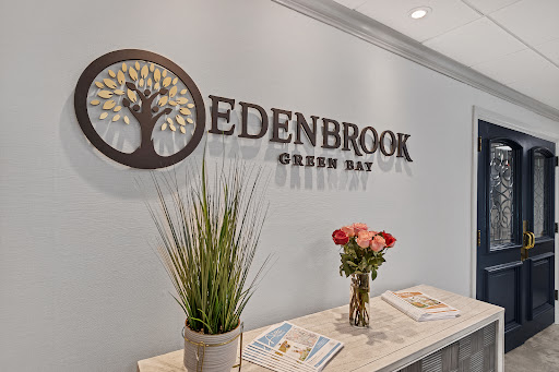The welcoming reception area of Edenbrook in Green Bay, featuring modern decor and floral arrangements.
