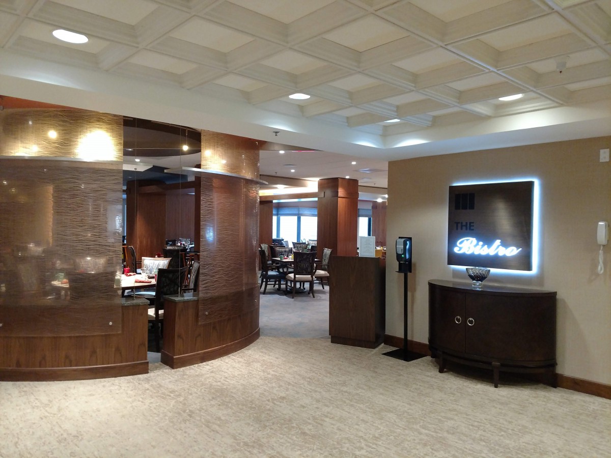 A modern dining area with elegant wood finishes and comfortable seating.