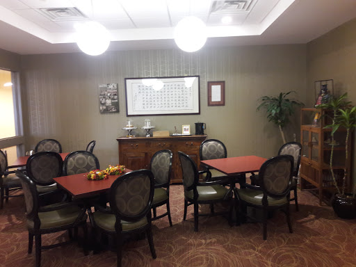 A cozy dining area featuring round tables and comfortable chairs, adorned with decorative elements.