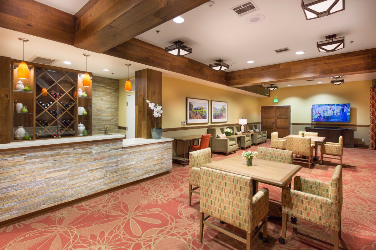 A modern hotel lobby with a reception desk and comfortable seating area.