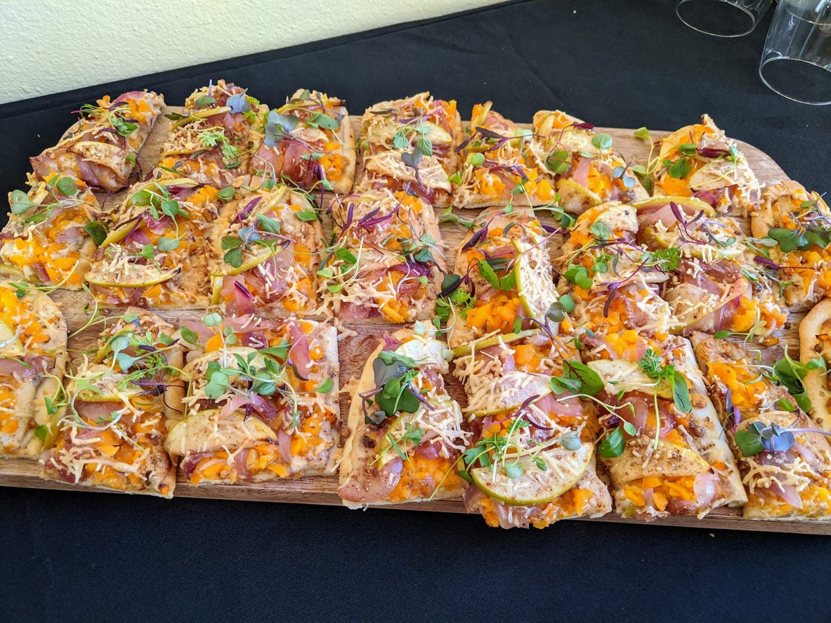 A platter of gourmet pizza slices with colorful toppings.
