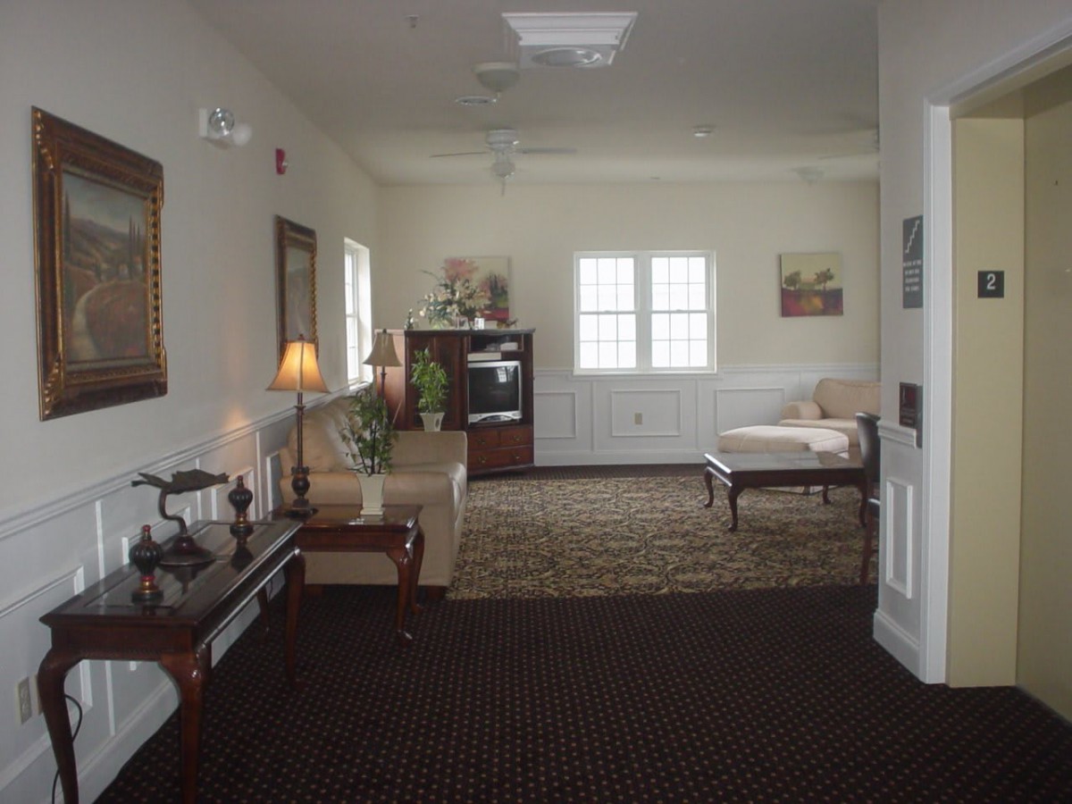 A cozy living room with classic furnishings and warm lighting.
