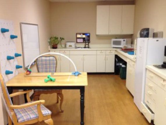 A small office kitchen area with a coffee maker, microwave, and refrigerator.