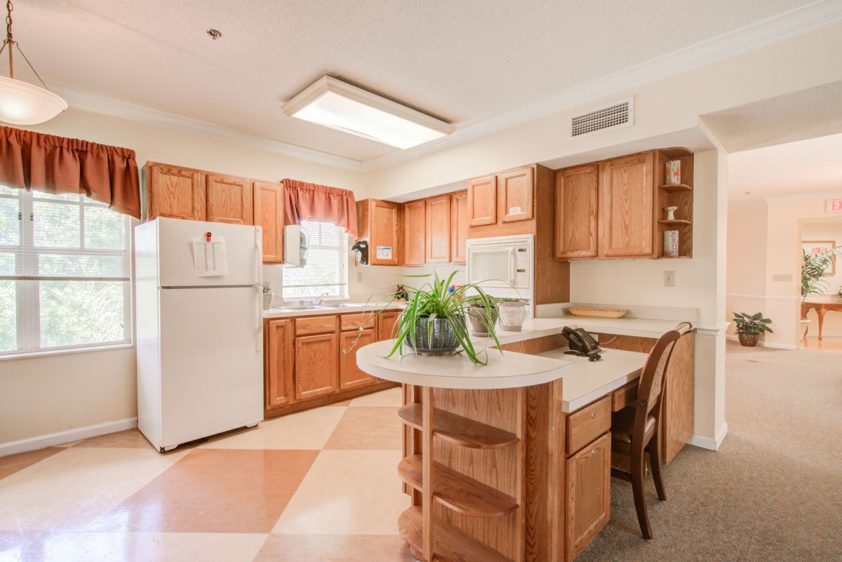 A spacious kitchen with wooden cabinets and a central island.