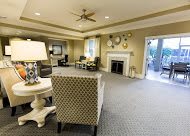 A cozy living room featuring comfortable seating, a fireplace, and elegant decor.