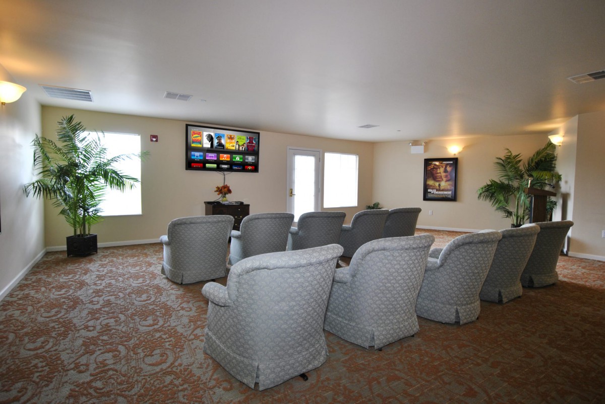 A cozy home theater room with comfortable seating and a large screen.