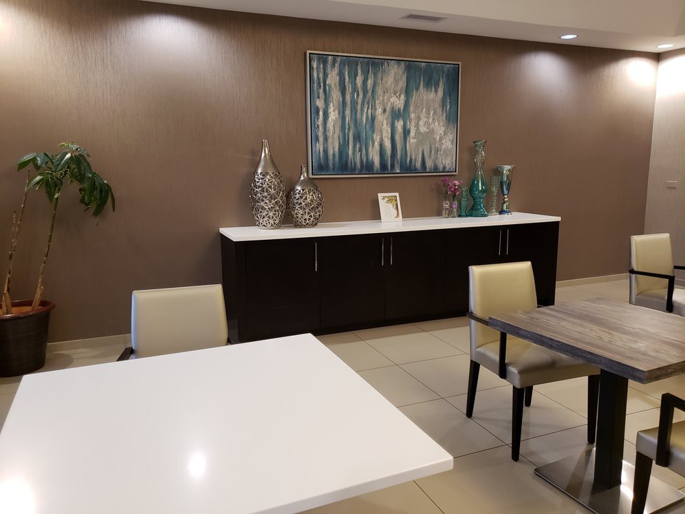 A modern dining room with contemporary furniture and decorative artwork.