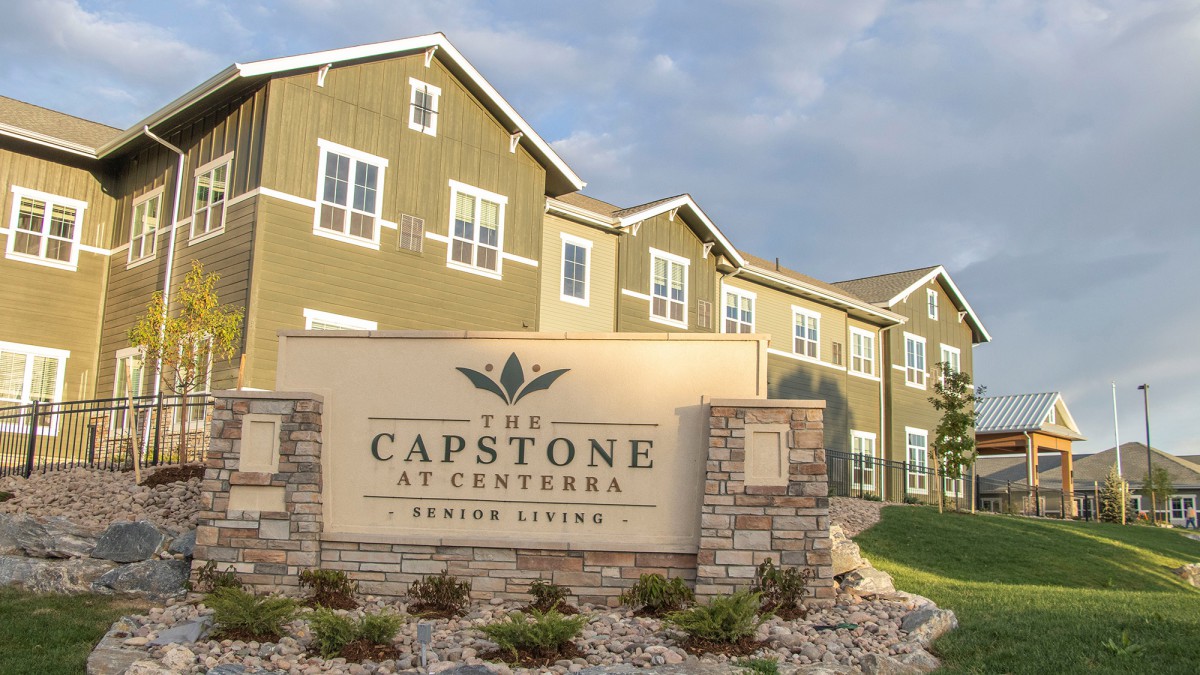 The Capstone at Centerra Assisted Living exterior view with signage.