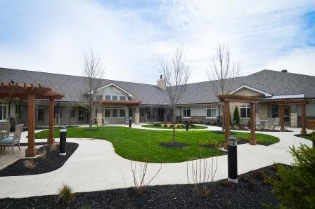 A courtyard with a central landscaped garden and pathways around a modern building.