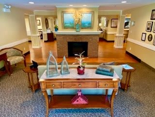 A beautifully decorated living room featuring a central fireplace and elegant furnishings.