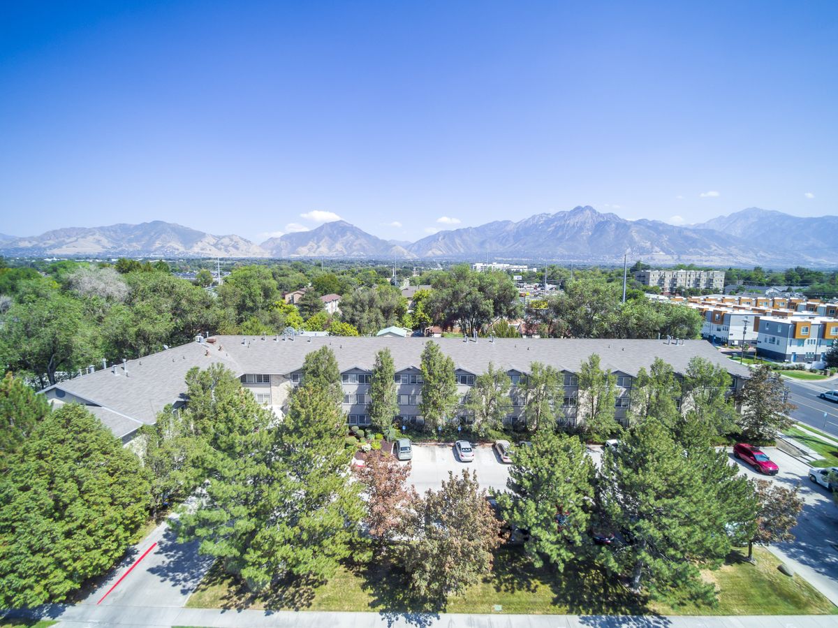 A scenic view of mountains and greenery under a clear blue sky.