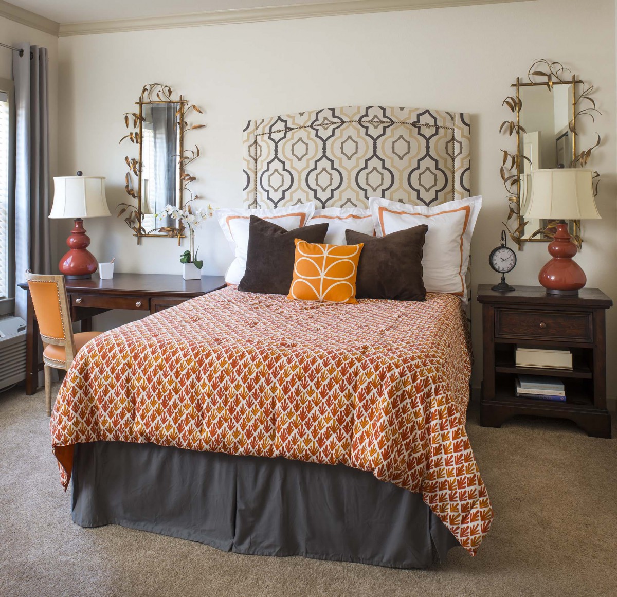 A cozy and stylish bedroom with patterned bedding and elegant decor.