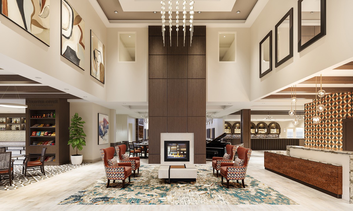 A luxurious hotel lobby with elegant seating and a central fireplace.