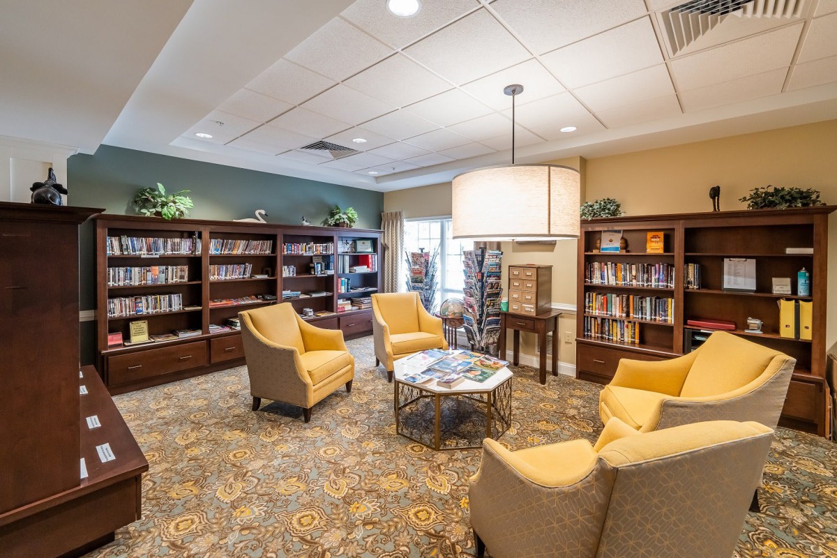 A cozy library reading area with chairs and bookshelves.