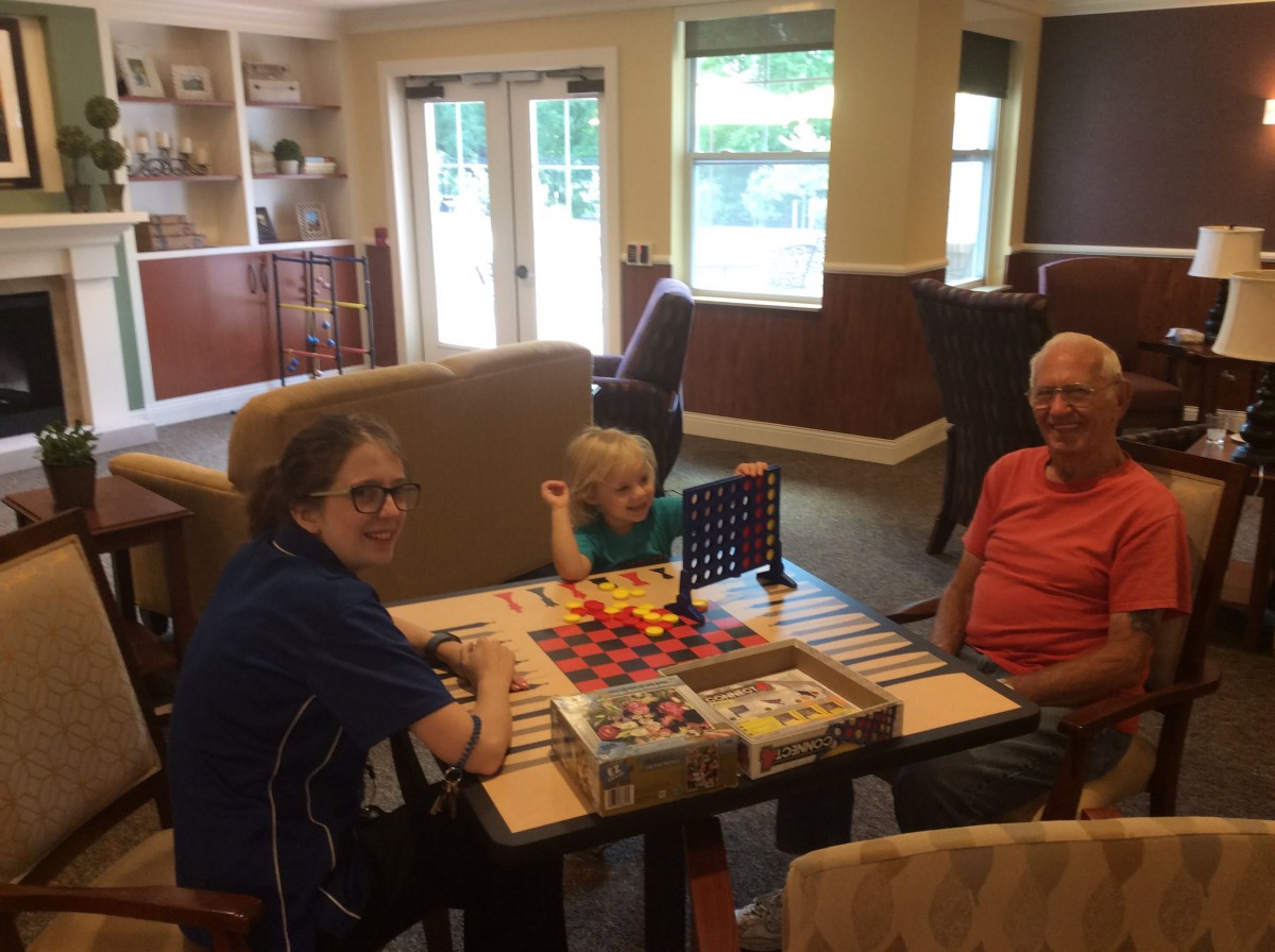 A family enjoying a board game together in a cozy living room.