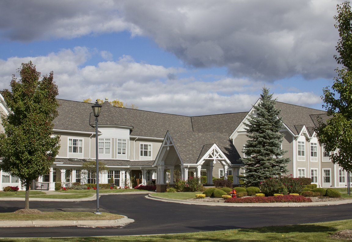 A spacious residential building under a cloudy sky.