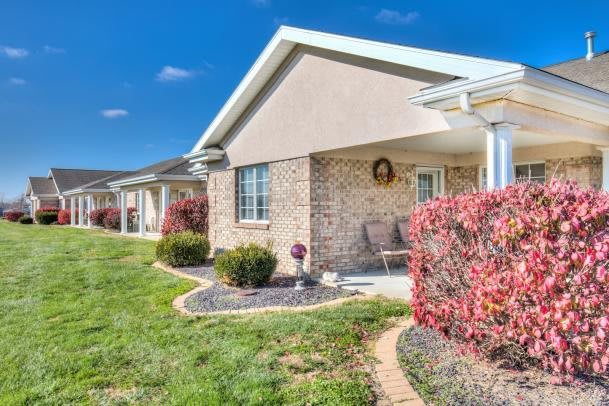 A well-maintained suburban house with a brick exterior and landscaped front yard.