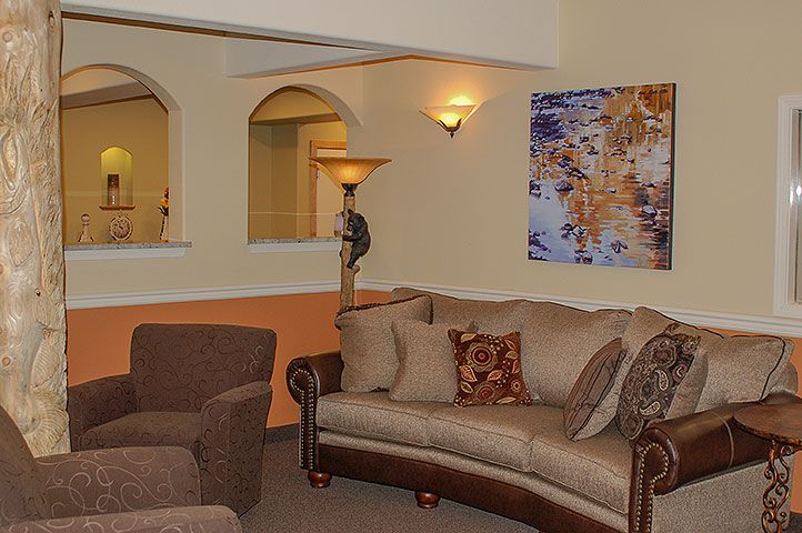 A cozy living room featuring comfortable seating and decorative artwork.