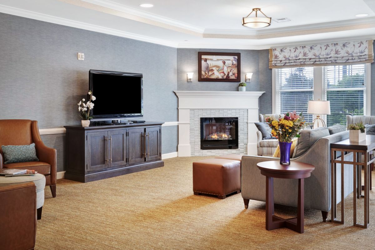 A modern living room with a television, fireplace, and comfortable seating.