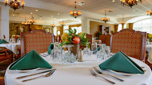 An elegant dining setup featuring a beautifully arranged table with floral centerpiece and stylish decor.