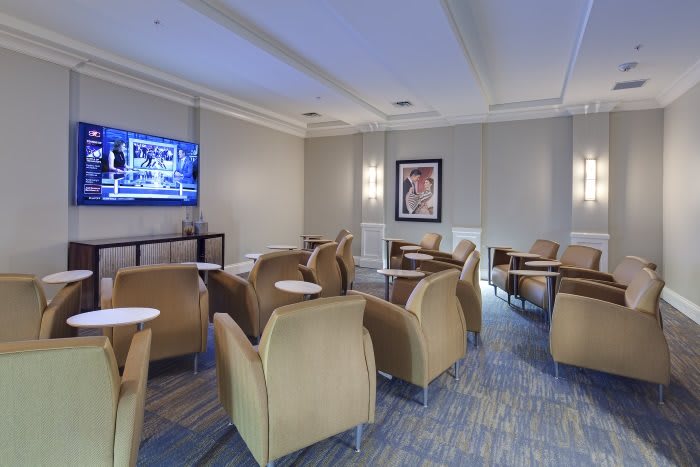 A modern lounge area with comfortable seating and a television.