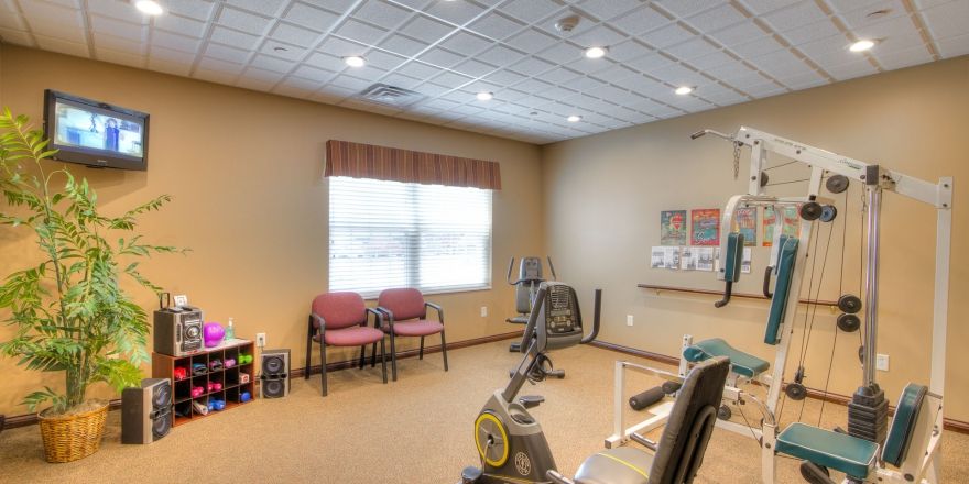 A small exercise room with equipment and seating.