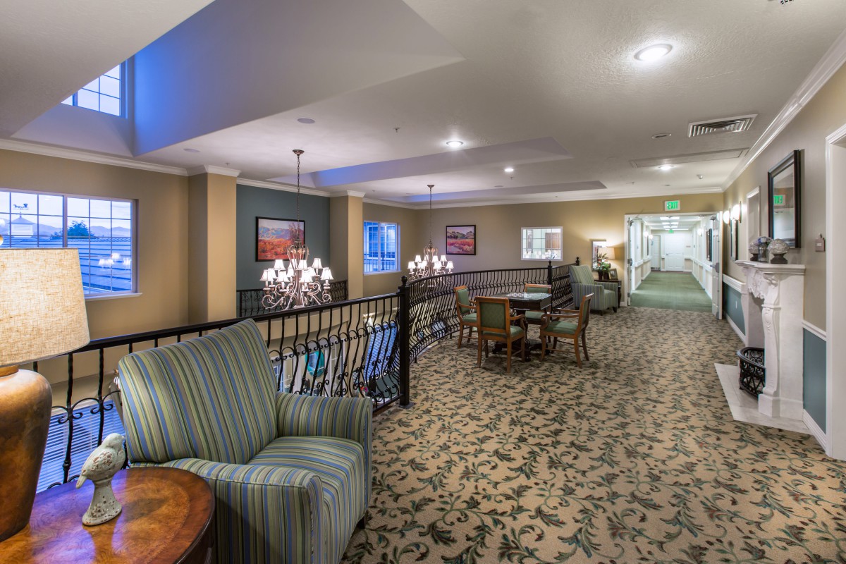 A cozy interior space featuring comfortable seating and elegant lighting.