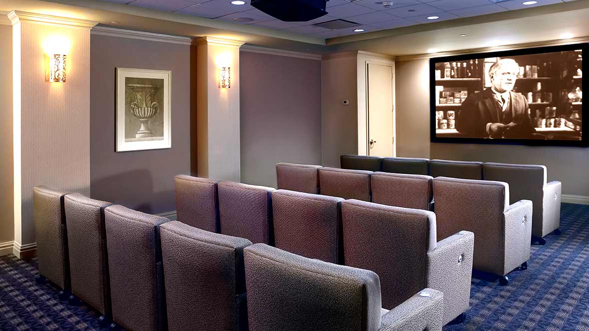 A cozy home theater with rows of comfortable seating and ambient lighting.