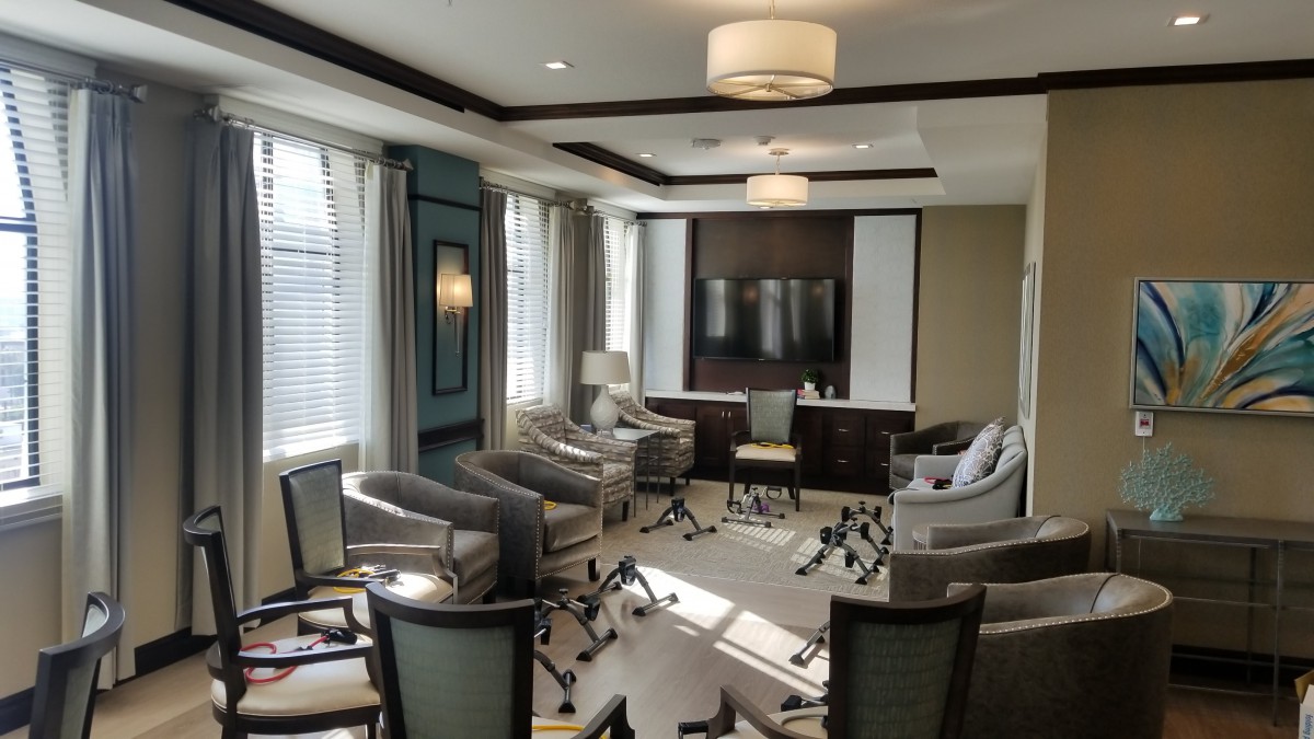 A modern conference room with ample natural light and comfortable seating.