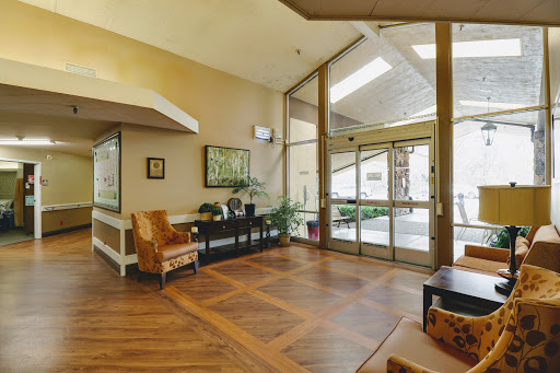 A welcoming lobby area featuring modern furniture, plants, and ample natural light.