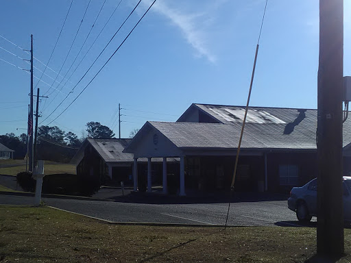 A building featuring solar panels on the roof, captured during a sunny day.