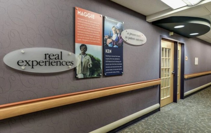 A hallway with informational posters and signage on the walls.