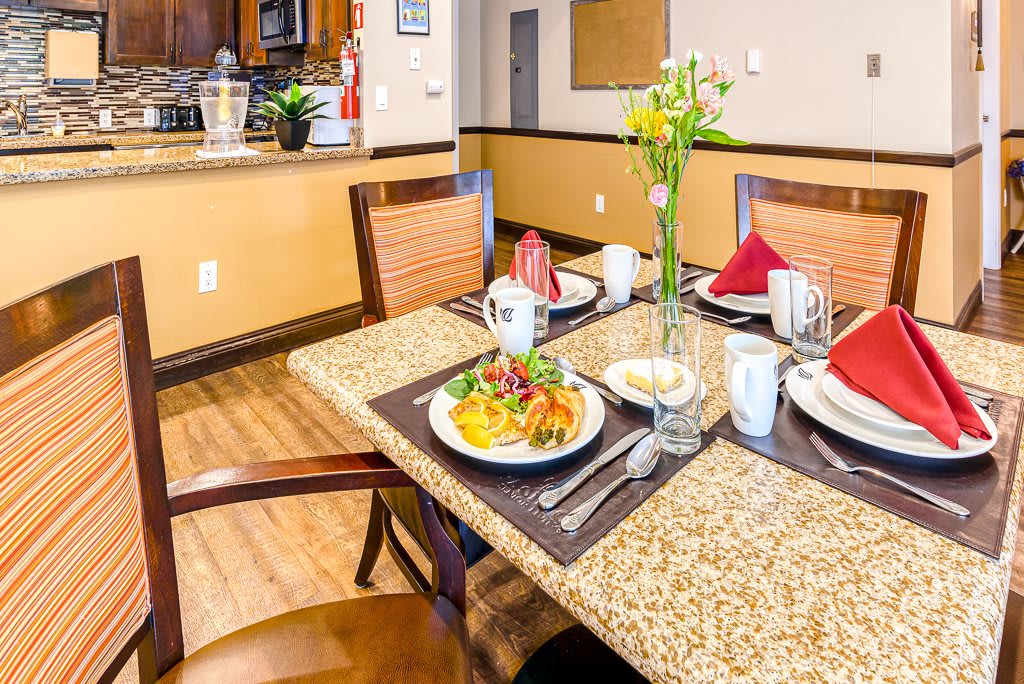 A beautifully set dining table with prepared meals and decorative elements in a cozy restaurant interior.