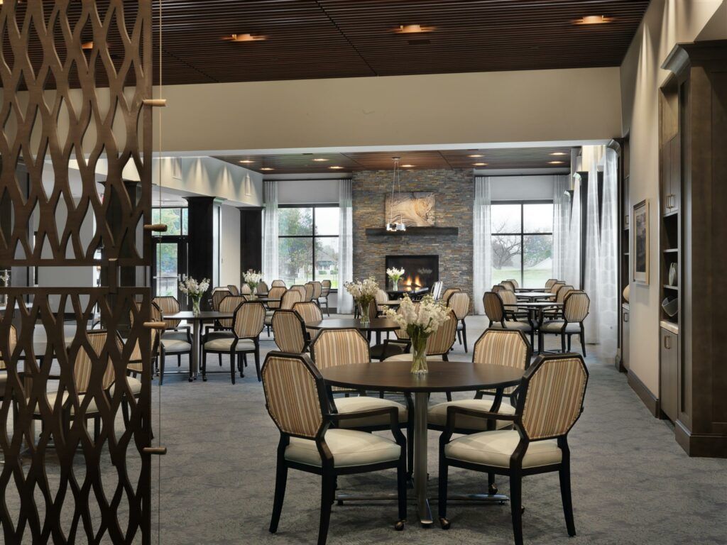 A cozy dining room with elegant furniture and a fireplace.