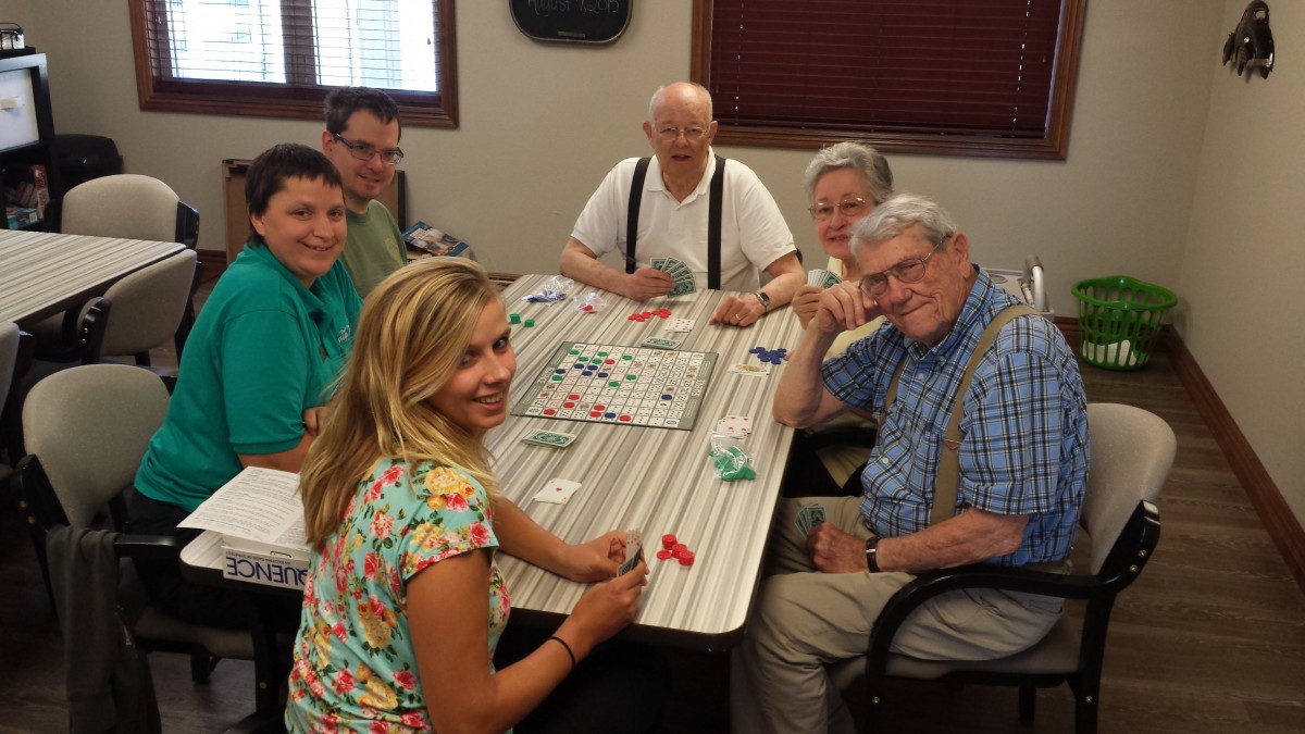 A group of people enjoying a board game together at a table.