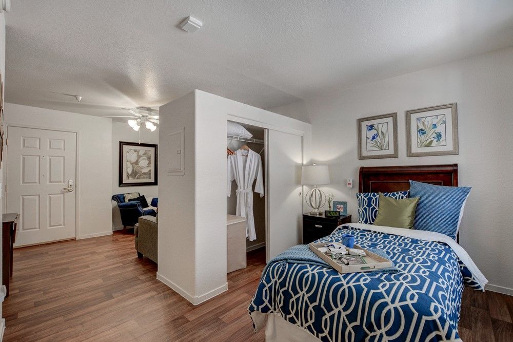 A cozy bedroom with modern decor and a neatly made bed.