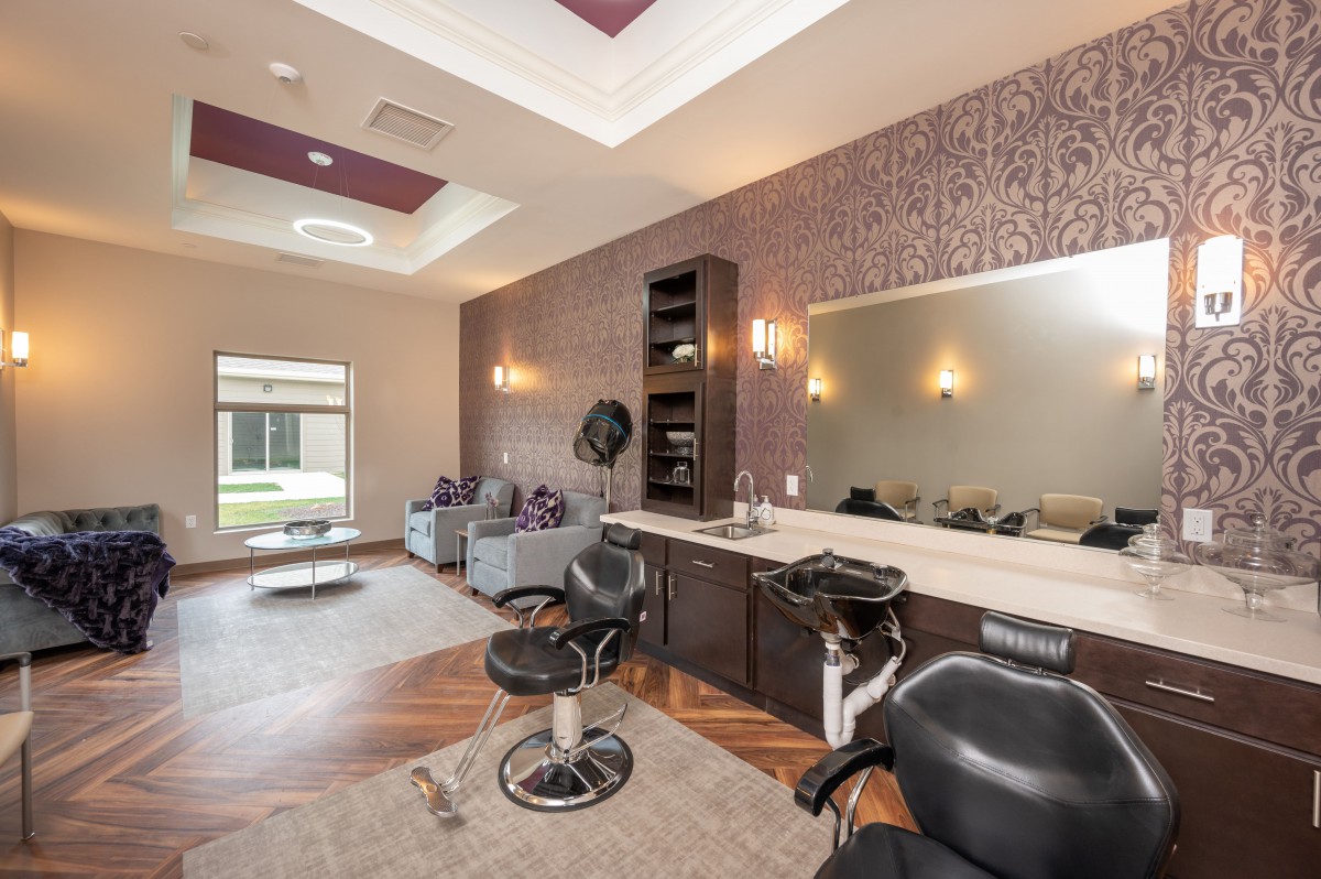 A modern salon interior featuring hairdressing stations and a waiting area.