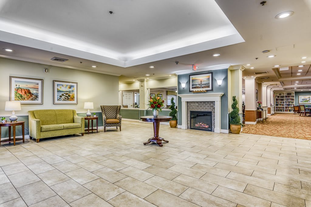A spacious and elegant lobby with comfortable seating, a fireplace, and tasteful decor.