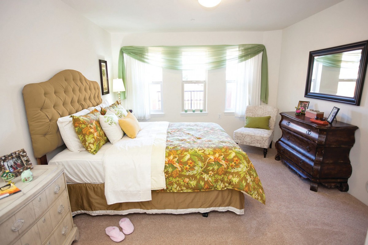 A cozy bedroom with elegant decor and ample natural light.