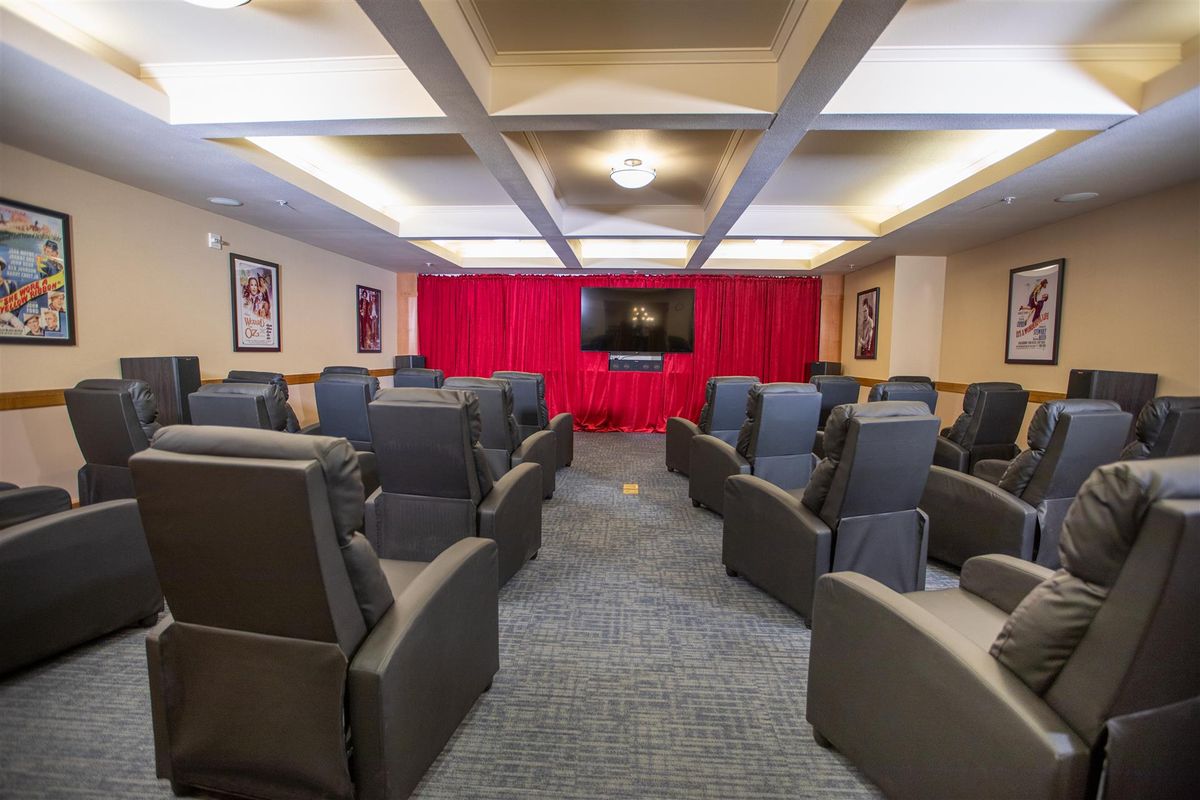 A cozy home theater with comfortable seating and a large screen, perfect for movie nights.