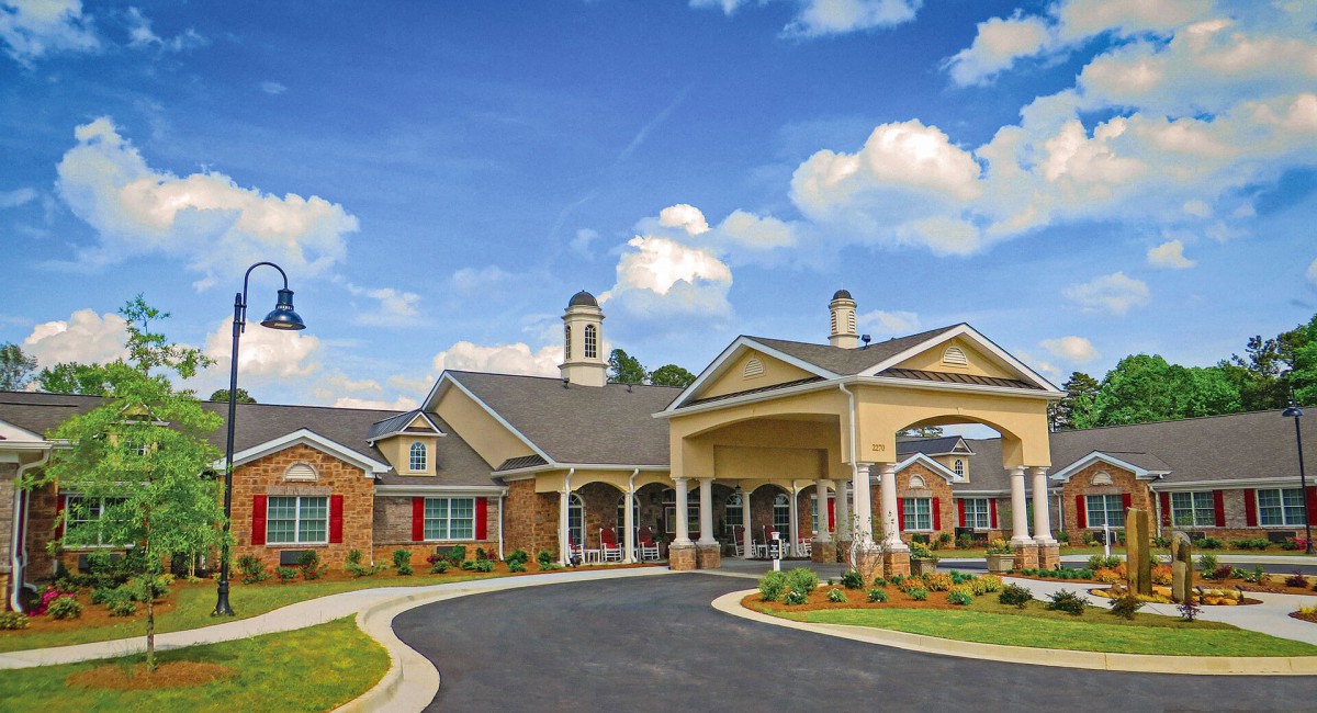 A picturesque view of a residential building with elegant architecture under a clear blue sky.