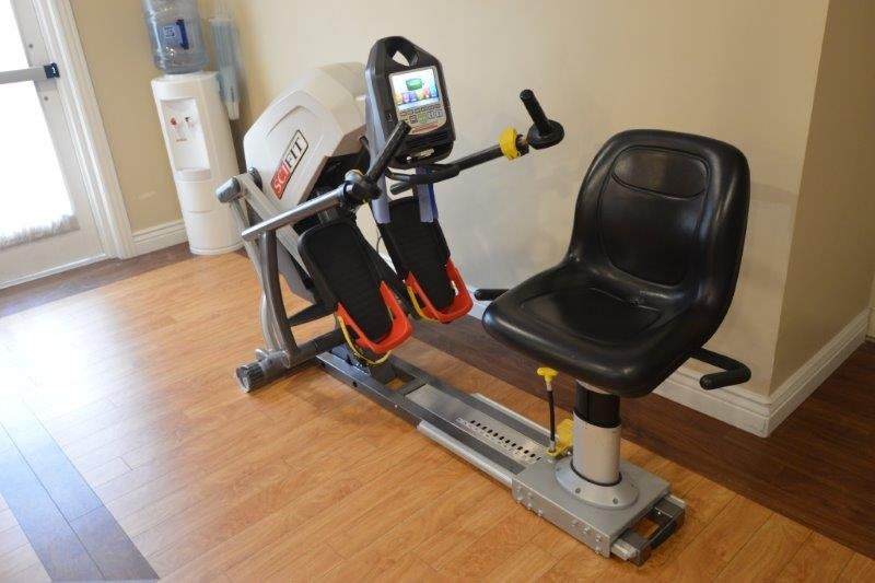 A seated exercise machine designed for rehabilitation and fitness training indoors.