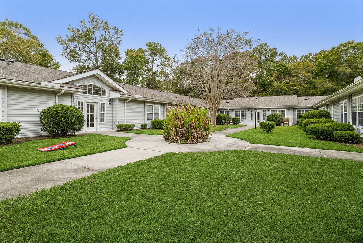 A peaceful suburban house with well-maintained lawns and pathways.