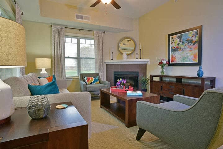 A cozy and stylish living room featuring a fireplace, comfortable seating, and modern decor.