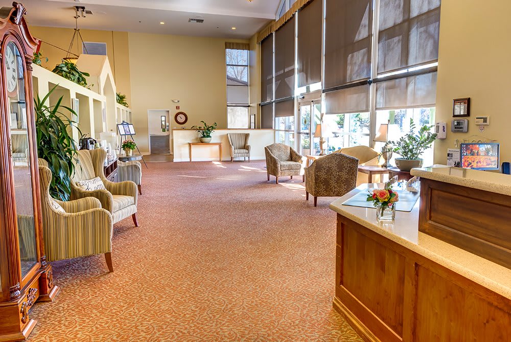 A spacious lobby with comfortable seating and large windows allowing natural light.