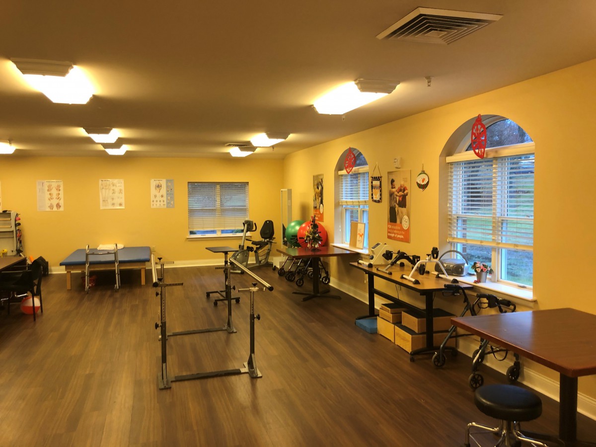 A physical therapy room equipped with exercise equipment and rehabilitation tools.