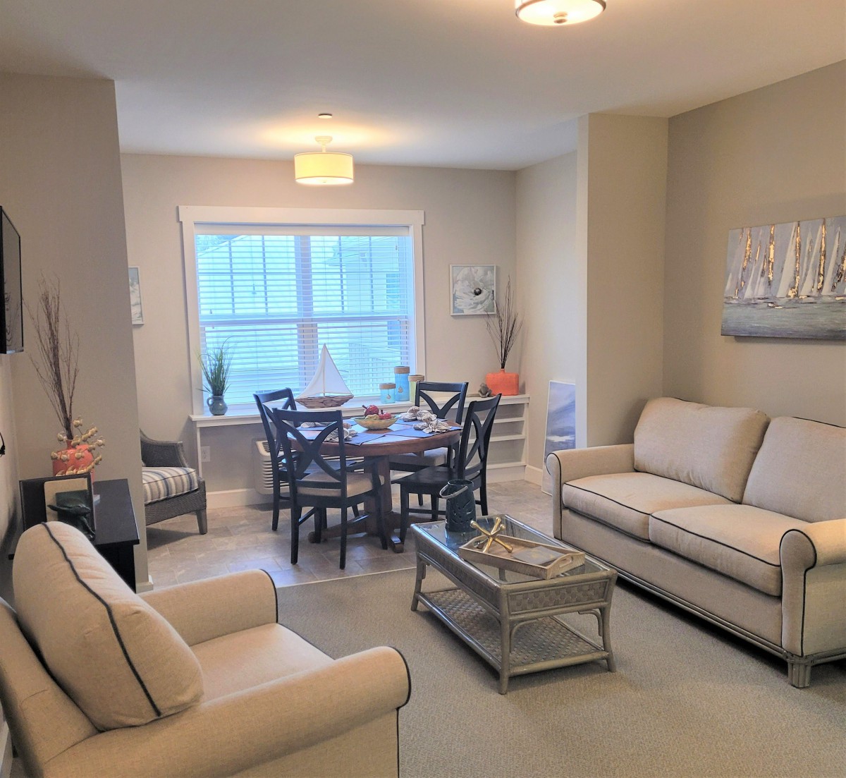A cozy living and dining space featuring comfortable furniture and soft lighting.