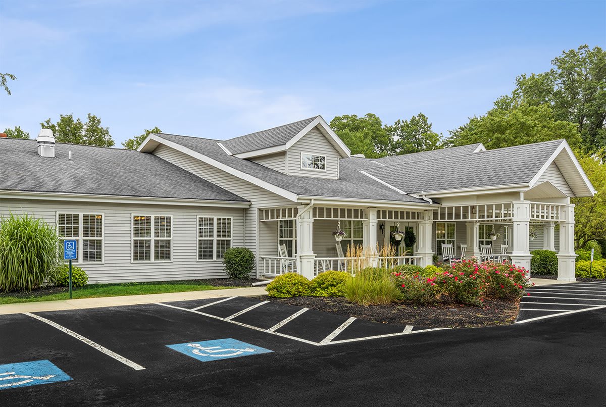 A single-story residential-style building with a landscaped front and an accessible parking space.